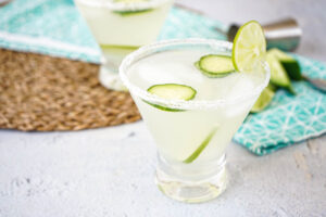 Cucumber-Lime Margaritas in two salt-rimmed glasses.