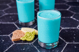 Galaxy's Edge Inspired Blue Milk in three glasses next to cookies.