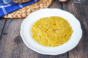 Risotto alla Milanese on a white plate.