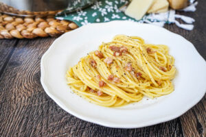 Classic Spaghetti Carbonara on a white plate.