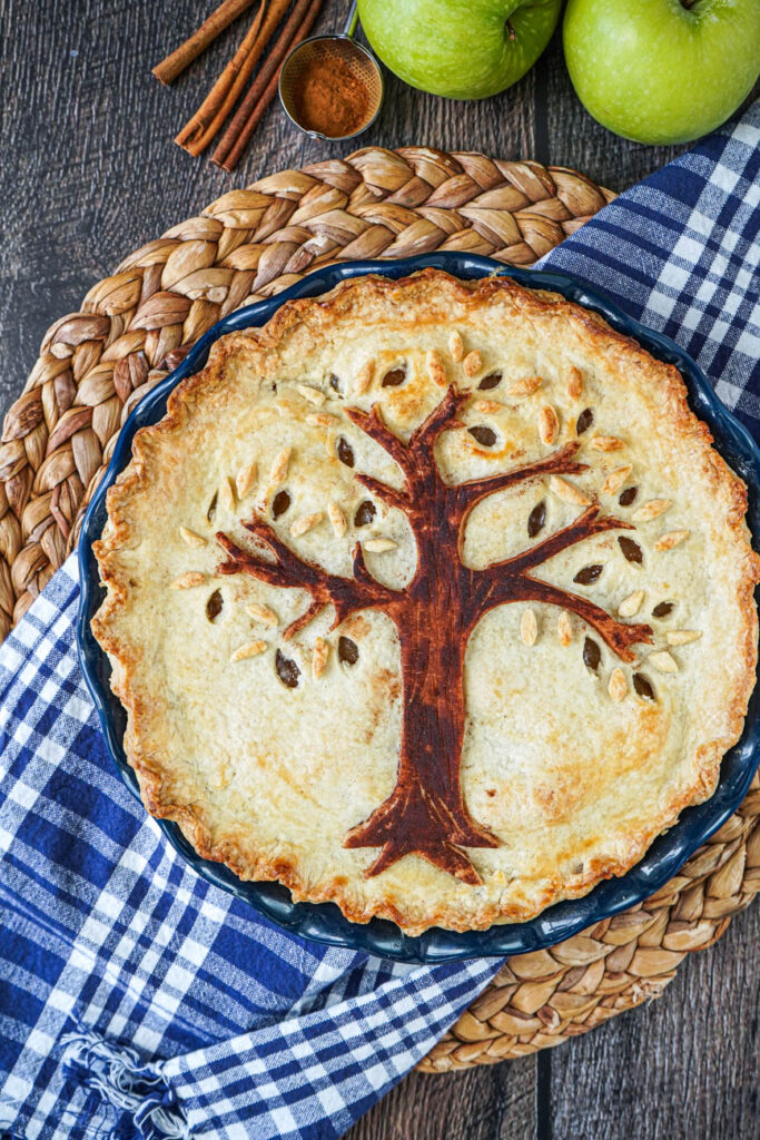 Aerial view of Harvest Tree Pie in a blue pie dish over a white and blue towel.