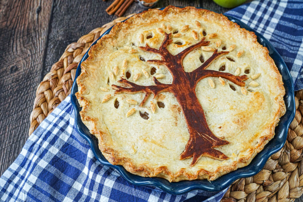 Harvest Tree Pie in a blue pie dish with a tree shaped pie crust on top.