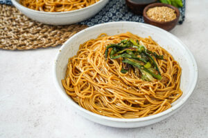 Shanghai Scallion Oil Noodles in a bowl with sesame seeds and scallions.