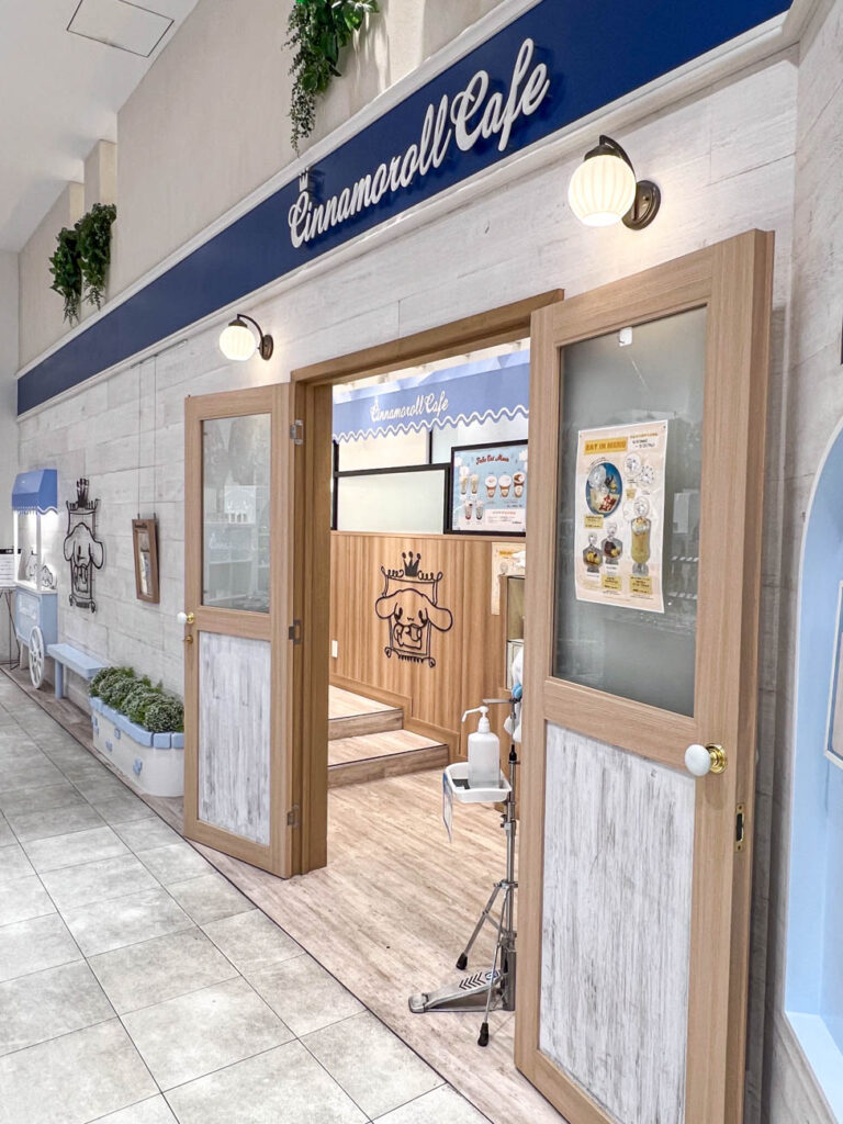 Entrance to Cinnamoroll Cafe with a menu on the door.