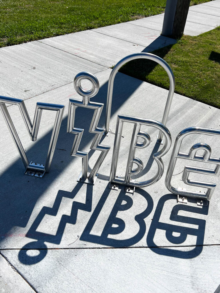 Bicycle Stand with word VIBE made of metal.