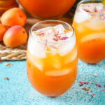 Rose, Apricot and Honey Iced Tea in two glasses next to dried rose petals.