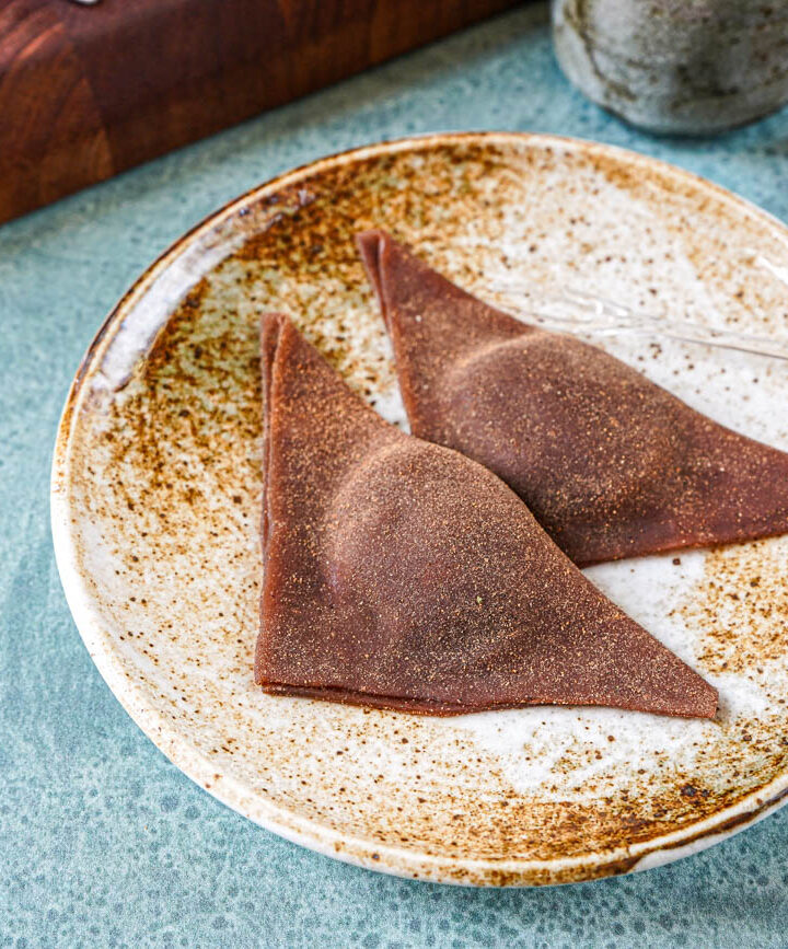 Two Chocolate Nama Yatsuhashi on a brown plate.