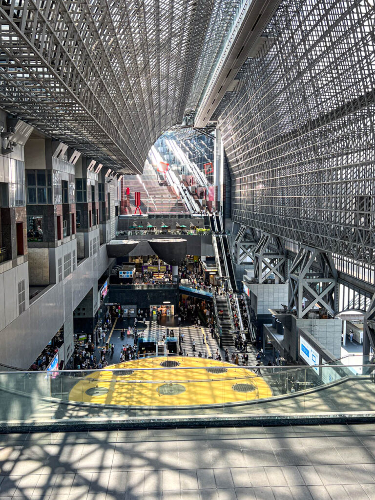 Side view of the main hall in Kyoto Station with escalators leading to the rooftop.