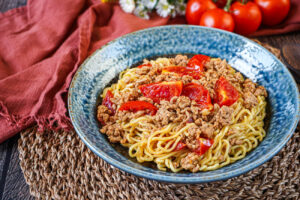 Tomato Curry Ramen in a blue bowl.