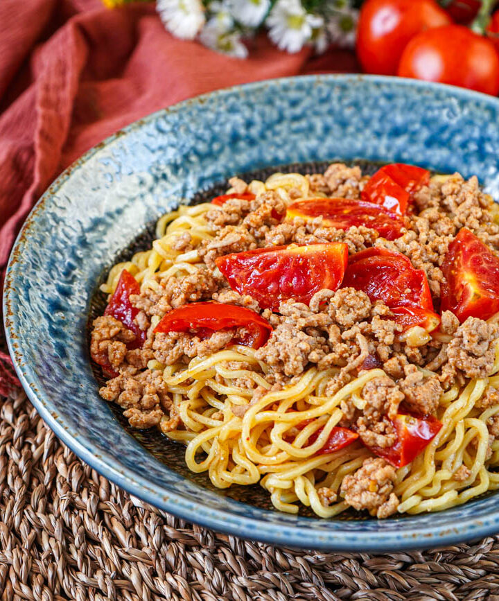 Tomato Curry Ramen in a blue bowl.