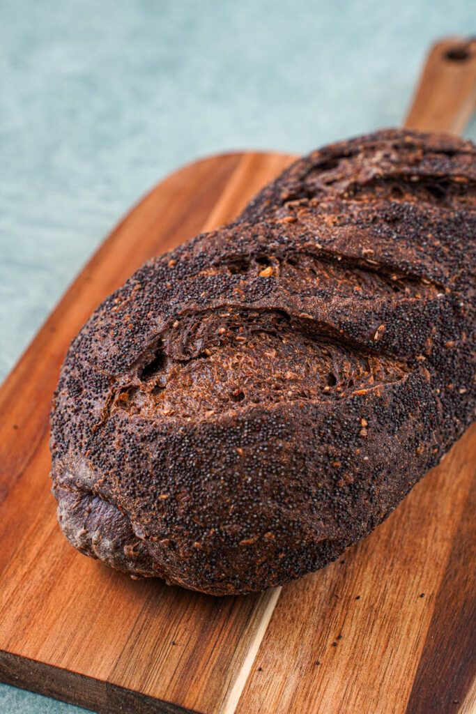 A loaf of Baltic Black Bread on a wooden board.