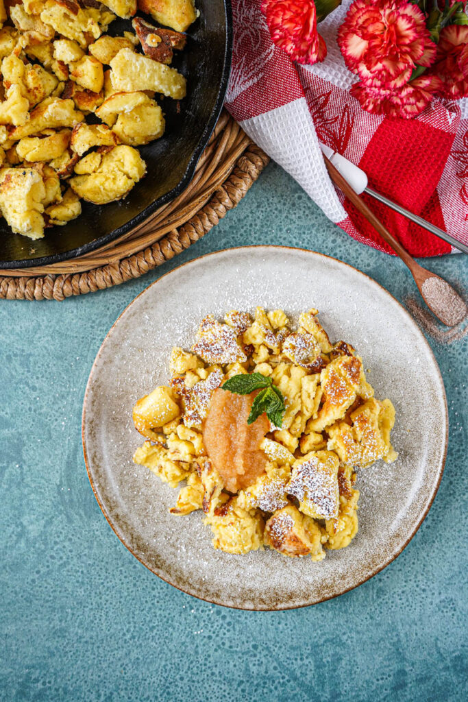 Aerial view of Cholermüs on a plate with more in a cast iron pan.