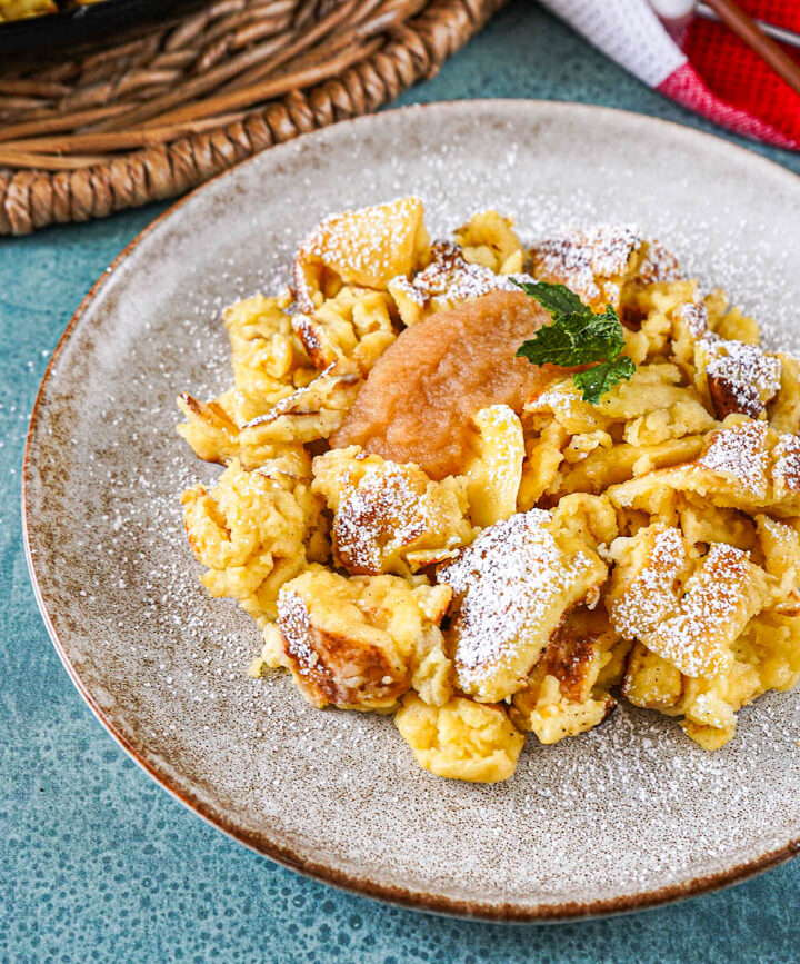 Cholermüs on a plate with applesauce and a mint sprig.
