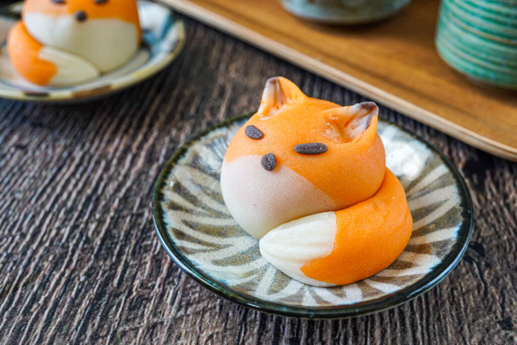 Fox Nerikiri on a small plate with another in the background.