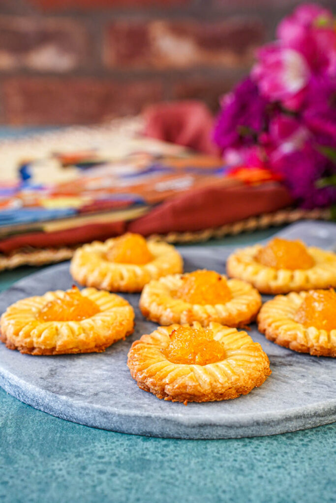 Side view of pineapple tarts on a marble board.
