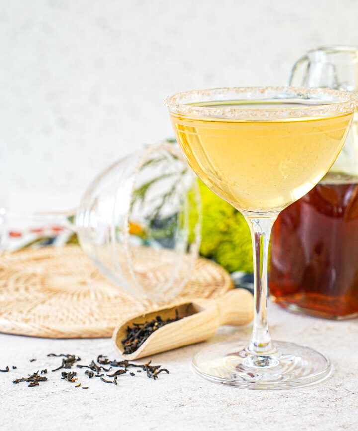 Smoky Lapsang Martini in a glass with Lapsang syrup in a jar in the background.