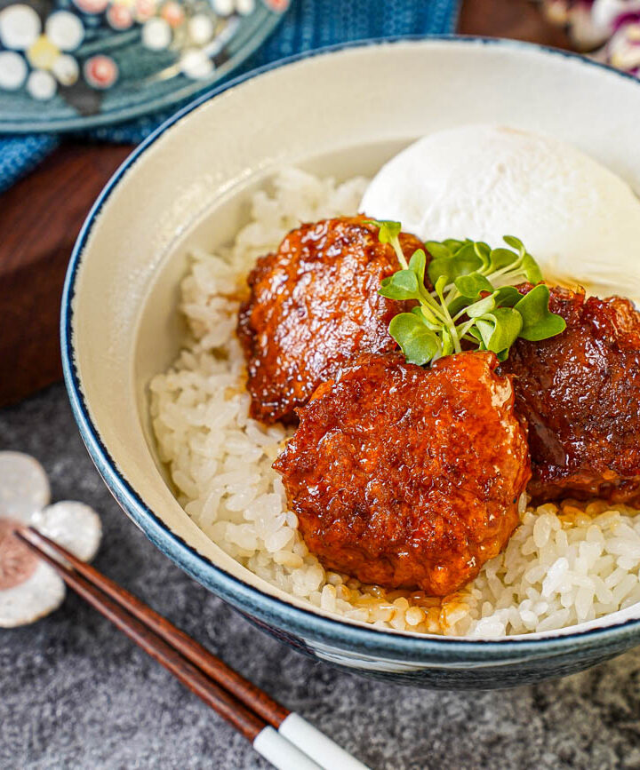 Three Chicken Meatballs (Tsukune) in a bowl with rice, bok choy sprouts, and a poached egg.