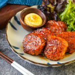 Tsukune (Chicken Meatballs) on a plate with lettuce and mayonnaise.