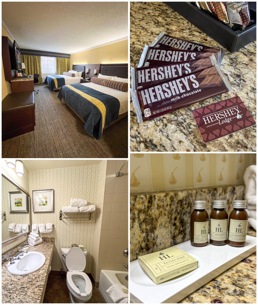 Queen room at Hershey Lodge with two queen beds, four Hershey bars, bathroom, and Hershey soap.