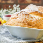 Salzburger Nockerl in a white baking dish with a dusting of powdered sugar.