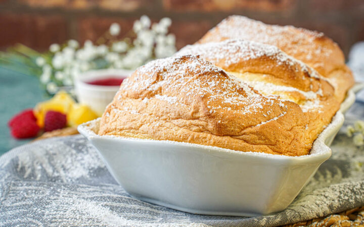 Salzburger Nockerl in a white baking dish with a dusting of powdered sugar.