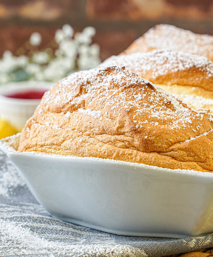 Salzburger Nockerl in a white baking dish with a dusting of powdered sugar.