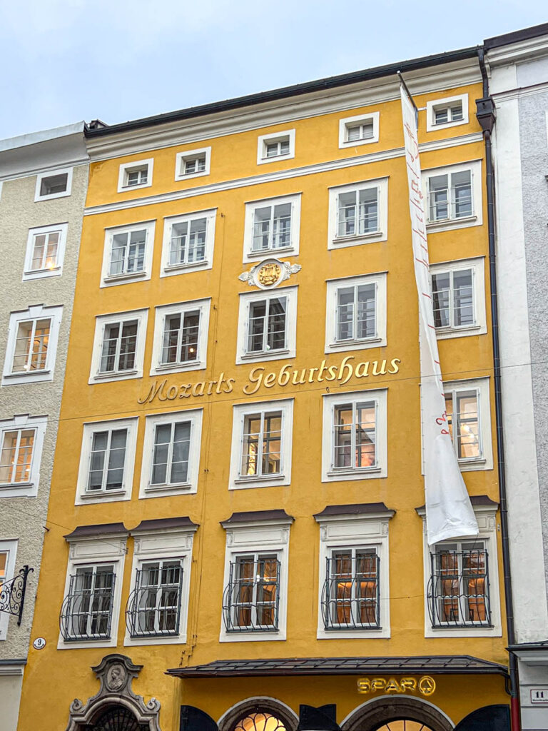 Mozarts Geburtshaus (Mozart's Birth House) on a yellow building.