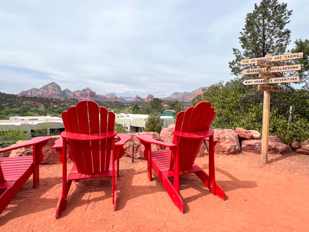 Red lawn chairs with view of red rocks.
