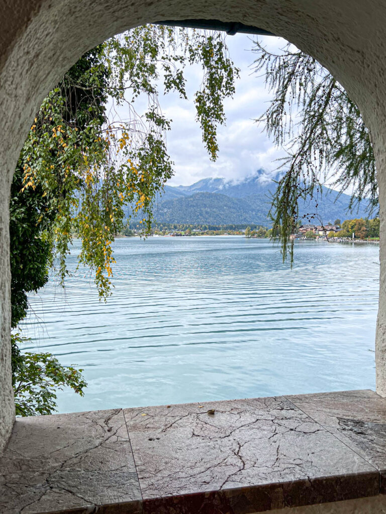 View of Wolfgangsee and mountains through a window.