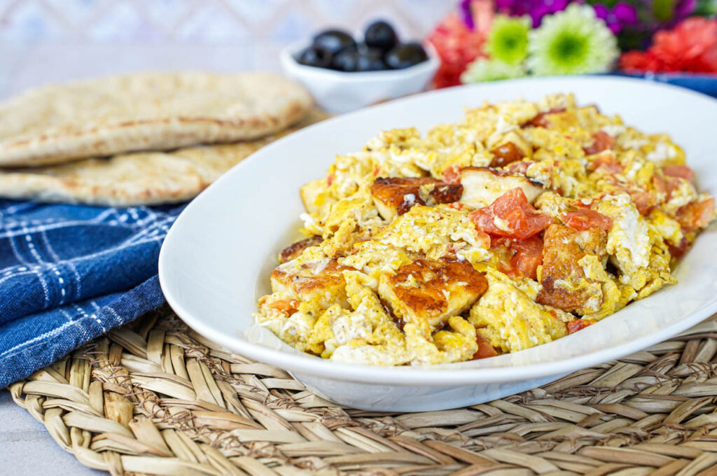 Scrambled Eggs with Halloumi on an oval white platter.