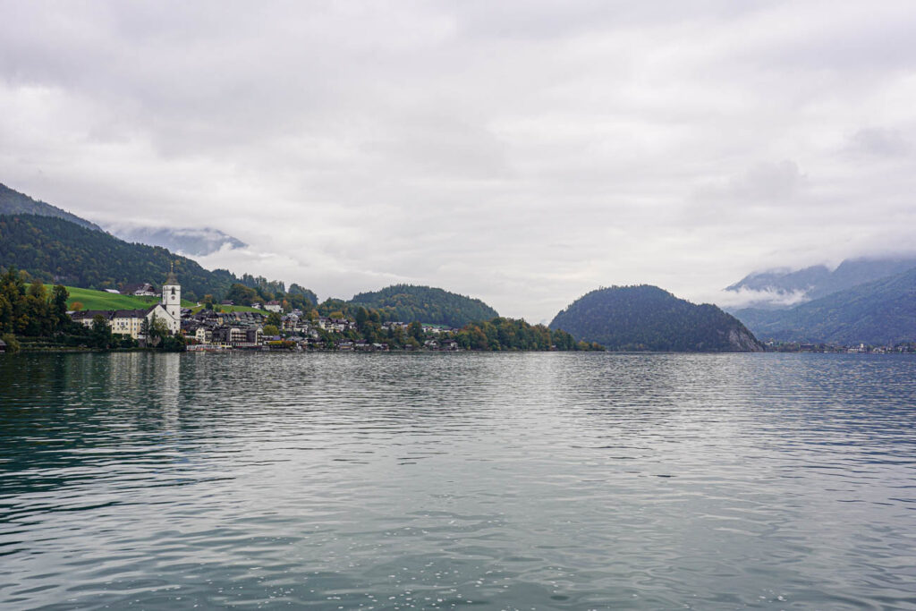 Waterfront view of St. Wolfgang with mountains in the background.