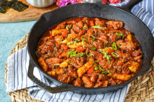 Dakgalbi (Spicy Stir-Fried Chicken) in a cast iron pan.
