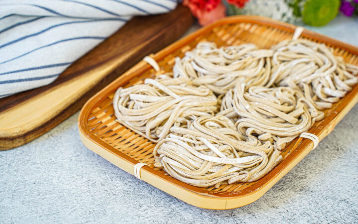 Five bundles of Homemade Soba in a bamboo basket.