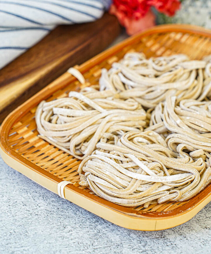Five bundles of Homemade Soba in a bamboo basket.