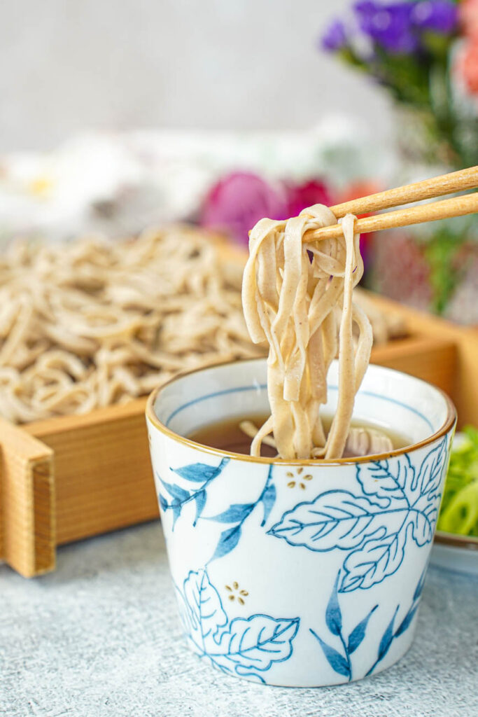 Dipping Homemade Soba into a broth.