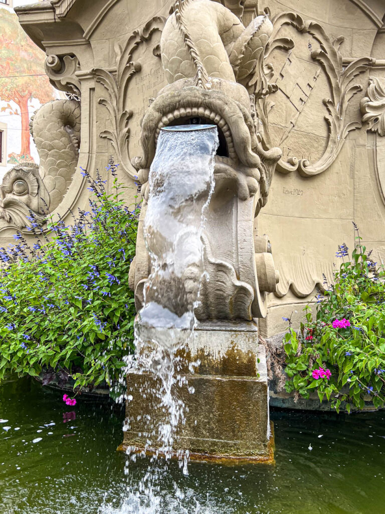 Water coming through a fish shaped fountain.