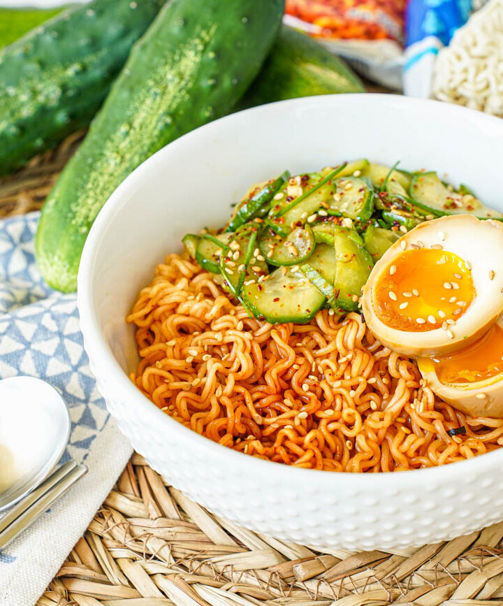 Korean Cucumber Salad Ramyeon in a white bowl with a halved egg.