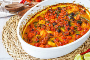 Coconut and Ginger Roasted Cherry Tomatoes in an oval baking dish.