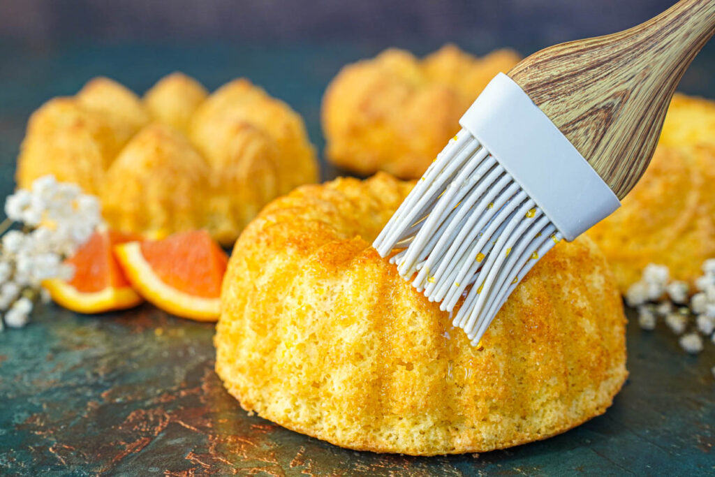 Brushing orange syrup over Meskouta.