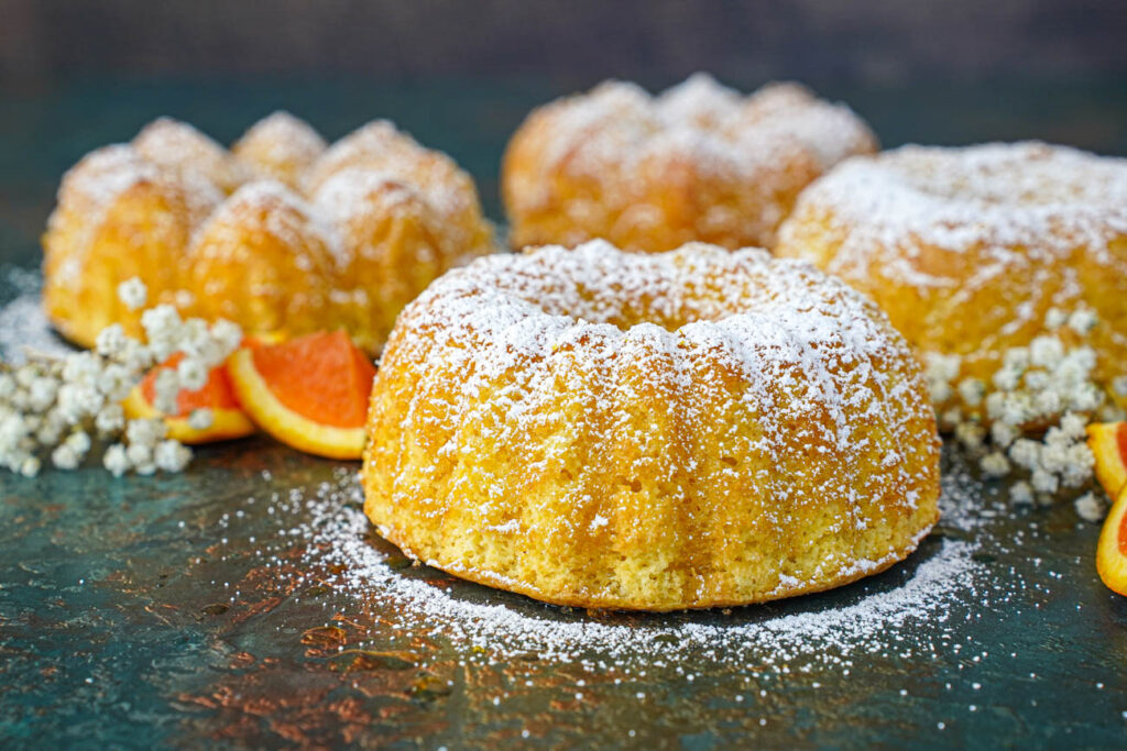 Four miniature Meskouta covered in powdered sugar.