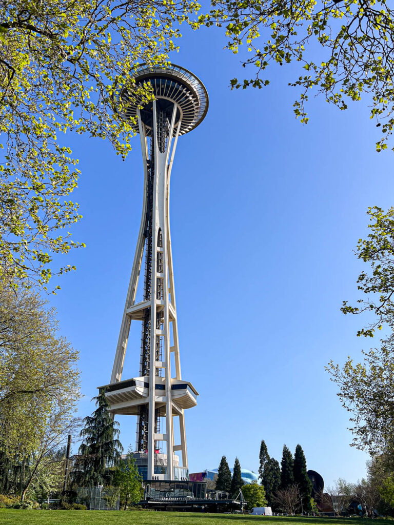Space Needle with trees in the frame.